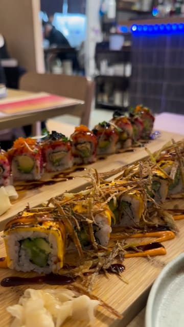 A montage of various sushi dishes, sesame toast, and desserts served at a restaurant. The video focuses entirely on the food presentation with no creator presence or venue atmosphere.
