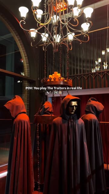 A promotional video showcasing The Traitors Live Experience in Covent Garden, highlighting the immersive set design, game elements, and the associated bar area.
