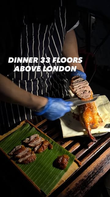 A short, visually appealing reel showcasing a dinner experience at Hutong in The Shard, London. The video features sweeping shots of the sunset view over London, the restaurant's interior, cocktails, and various dishes including Peking duck and dim sum.