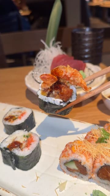 A review of Sticks'n'Sushi in Glasgow, featuring a variety of dishes including beef tataki, sushi rolls, grilled skewers, and a matcha chocolate pudding dessert. The video uses a vlog-style format with voiceover commentary to highlight the dining experience.
