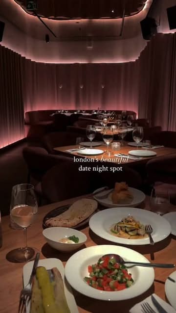 A cinematic, slow-paced montage showcasing the interior and food offerings of a London restaurant, focusing on its suitability for a date night.