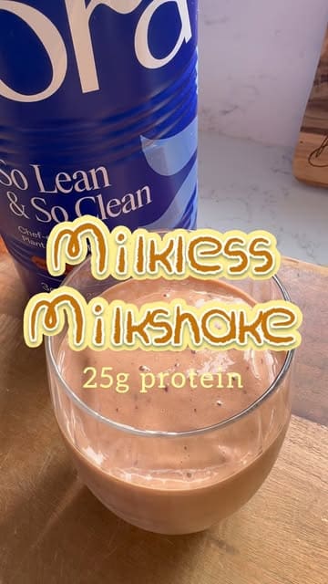 A short recipe video demonstrating how to make a vegan, high-protein chocolate milkshake using frozen fruit and protein powder.
