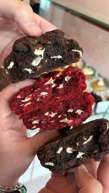 A short promotional video showcasing a visit to the cookie and doughnut shop 'Gooey' at Meadowhall. The video features close-up shots of various cookies and doughnuts, a look at the menu, and the preparation of drinks, ending with a satisfying pull-apart shot of the cookies.