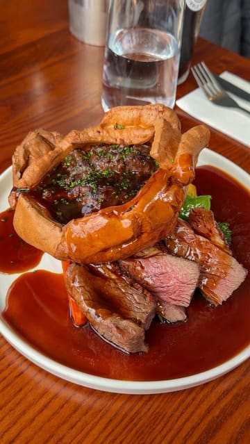 A review of a Sunday roast at The Eagle and Child in Ramsbottom, highlighting the braised beef stuffed Yorkshire pudding, the option to upgrade to steak, and the beer garden.