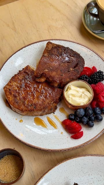 A short, engaging video showcasing a day trip to Slaithwaite, highlighting a canal walk and a visit to The Handmade Bakery. The video features shots of the canal, the bakery's interior, fresh bread, and plated dishes like cinnamon toast and mushrooms on toast.