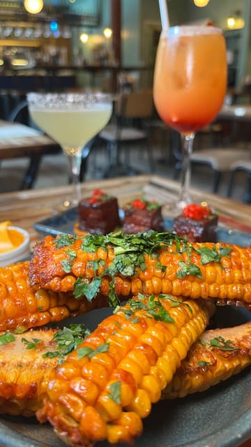 A promotional reel for a Peruvian-Japanese (Nikkei) restaurant in Soho, London, showcasing their tasting menu and cocktails. The video features close-up shots of various dishes, including corn ribs, ceviche, and meat dishes, alongside vibrant cocktails, set to music with text overlays describing the experience.