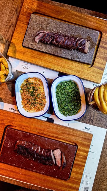 A short, edited montage showcasing a new steak restaurant in Bristol. The video features close-ups of steak, sides like mac and cheese and creamed spinach, the restaurant interior, and the complimentary ice cream served at the end.