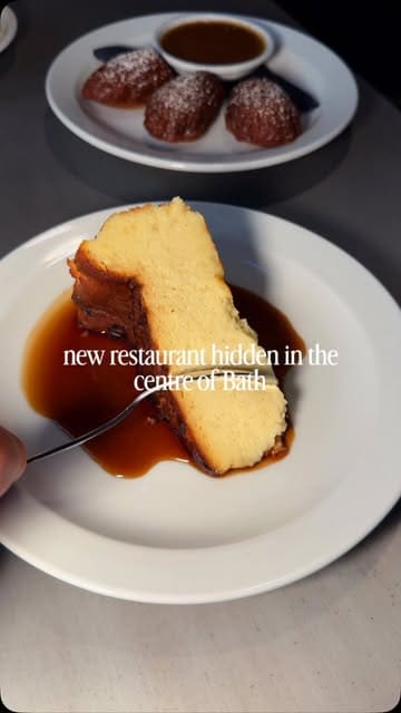 A short, polished montage showcasing a new restaurant in Bath, focusing on their Sunday roast offerings, including roast beef, porchetta, and desserts like burnt Basque cheesecake and sticky toffee madeleines.