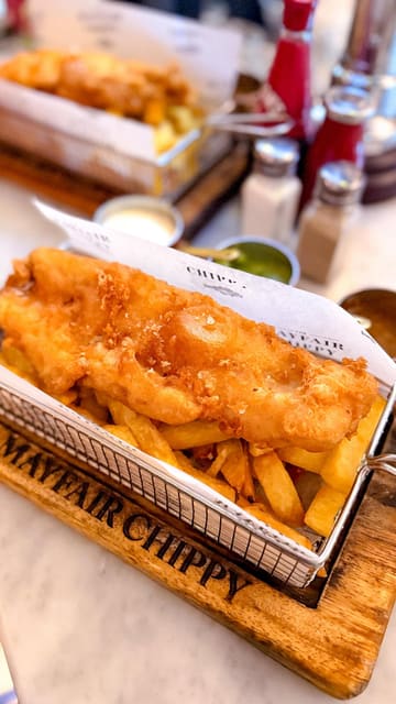 A short, energetic reel showcasing a visit to The Mayfair Chippie in Knightsbridge. The video features quick cuts of the entrance, the menu, the interior, and close-ups of the fish and chips being served and eaten.