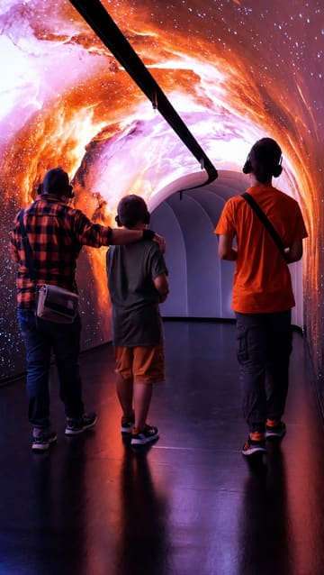 A montage showcasing the Timewalk Exhibition in London, featuring immersive projections and interactive historical displays. The video highlights the experience of walking through different eras, emphasizing the engaging and educational nature of the venue for families and visitors.