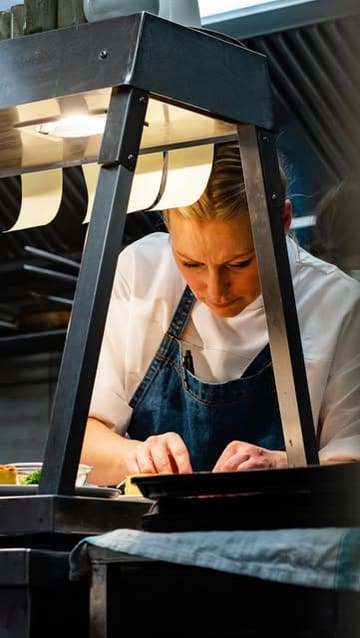 A chef at Myrtle restaurant discusses the importance of integrity and 'heartbeat' in dish creation, interspersed with shots of intricate plating and service in a fine dining setting.