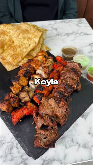 A creator visits Koyla in Manchester to review their Pakistani street food offerings, including the Anda Wala Burger, mixed grill platter, Shahi Beef Haleem, and the weekend special Beef Nalli Biryani, finishing with Ras Malai.
