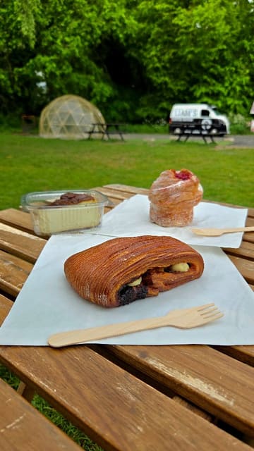 A short video showcasing the pastries and outdoor setting of Liam's Coffee House, featuring close-ups of various baked goods and the coffee van location.