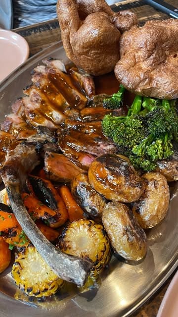 A review of the Sunday roast and other dishes at Arcadian restaurant in Didsbury, highlighting the open-fire cooking style and the quality of the food.