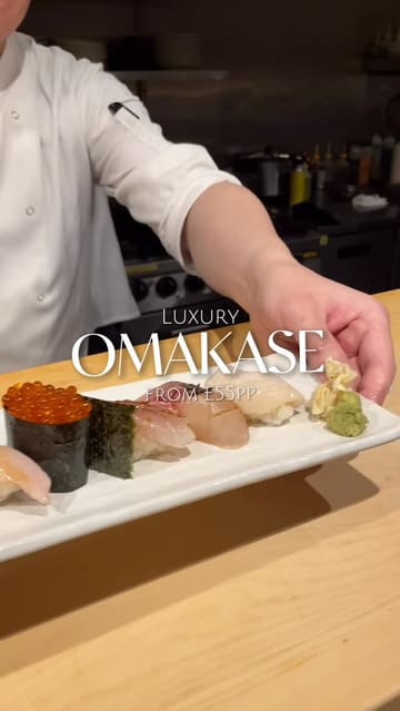A short, polished montage showcasing an omakase dining experience at INÉ. The video features close-up shots of various sushi and sashimi courses being prepared and served at an intimate counter, accompanied by text overlays detailing the price point.