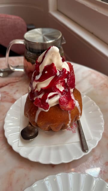 A montage showcasing the aesthetic interior and menu items at Le Café by Nicolas Rouzaud, featuring close-ups of pastries, brunch dishes like eggs benedict, and drinks.