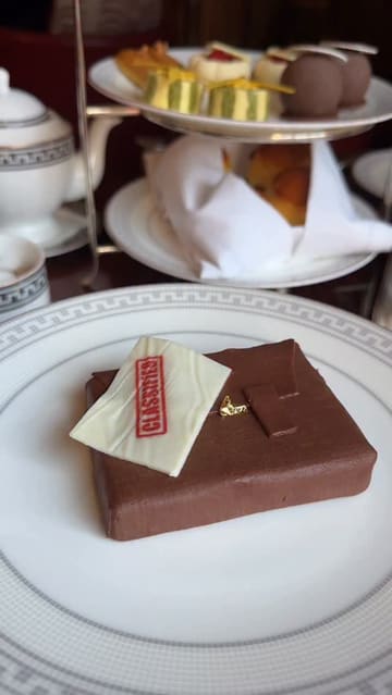 A short, aesthetic video showcasing a themed 'Operation Mincemeat' afternoon tea at Raffles London. The video features close-up shots of intricate, spy-themed pastries and sandwiches, set against the backdrop of an elegant hotel dining room.