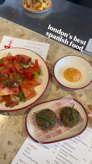 A creator visits Barrafina in London to highlight their participation in the 'Eat Spain Drink Spain' event, showcasing various tapas dishes like cuttlefish croquetas, fideua, and tortilla with caviar, alongside wine pairings and the restaurant's counter-dining atmosphere.