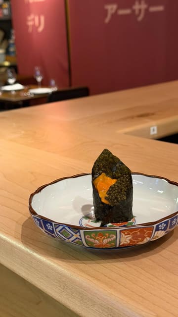 A montage of high-quality omakase sushi dishes being prepared and served at a restaurant in Chelsea, London. The video focuses on close-up shots of premium ingredients like uni, caviar, and prawns, set to music with minimal text overlays.
