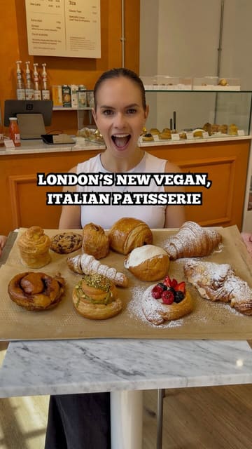 A vibrant and informative reel featuring a visit to a new vegan Italian patisserie in London. The creator provides a tour of the shop and the kitchen, highlights the technical skill involved in vegan baking, and samples a variety of pastries, including cruffins, cannoli, and cinnamon buns.