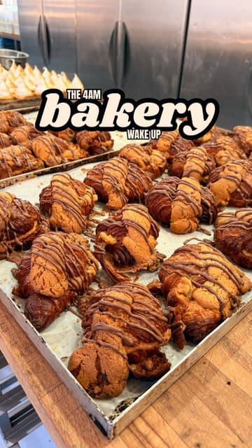The creator visits Medicine Bakery in Wolverhampton at 3:45 AM to document the early morning baking process. The video follows the staff as they prepare various pastries, including croissants and doughnuts, for distribution across the bakery's multiple sites. It concludes with the creator sampling the finished products at the cafe.