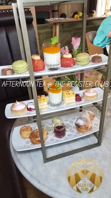 A high-quality reel showcasing 'The Grand Afternoon Tea' at The Register Club in Edinburgh. The video features close-up shots of the three-course menu, including savoury items like lamb kofta and smoked salmon bagels, a deconstructed cranachan palate cleanser, and a selection of sweet treats. The editing is clean, with text overlays detailing the menu items, providing a clear and enticing overview of the experience.