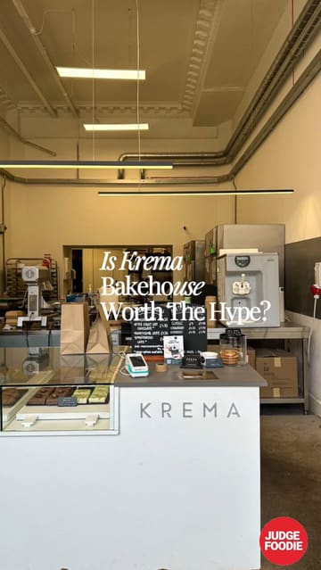 A short, edited montage showcasing the interior and product display of Krema Bakehouse in Edinburgh, featuring various pastries, cakes, and a menu board.