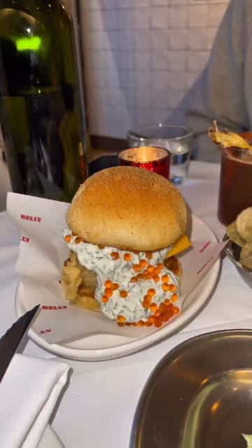 A video review of a Filipino-European bistro in London, featuring a variety of dishes including cured scallops, tempura cod, steak tartare, and a mushroom rice dish, alongside cocktails. The creator provides commentary on the food and the overall dining experience.