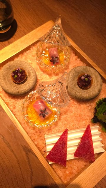 A cinematic reel showcasing an 8-course woodfire-led tasting menu at IGNI in Mayfair. The video features close-up shots of intricate plating, the kitchen team at work, and the counter seating experience.