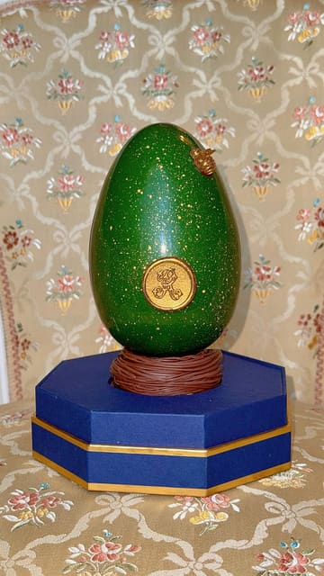 A short, polished unboxing video of a luxury handmade chocolate Easter egg from The Ritz London, featuring gold detailing and elegant packaging.