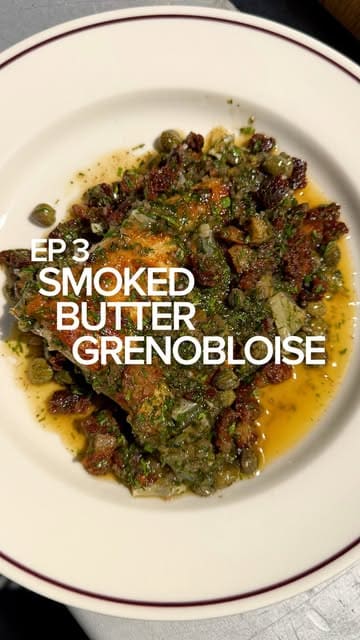 A cooking tutorial demonstrating how to smoke butter and use it to prepare a Grenobloise sauce for a piece of brill fish.