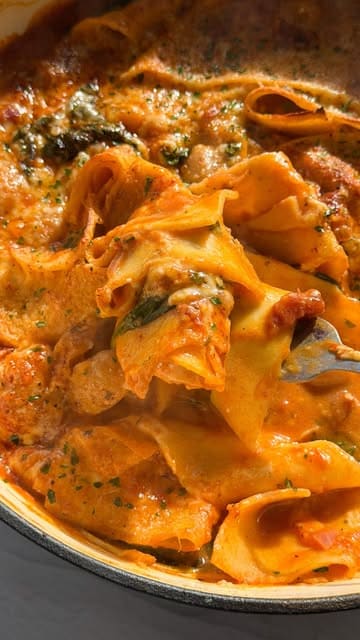 A home cooking tutorial video where the creator demonstrates how to make a 'Marry Me Butter Bean Lasagne' as part of a budget-friendly meal series. The video features the creator preparing the dish step-by-step, with clear instructions and appetizing shots of the final result.