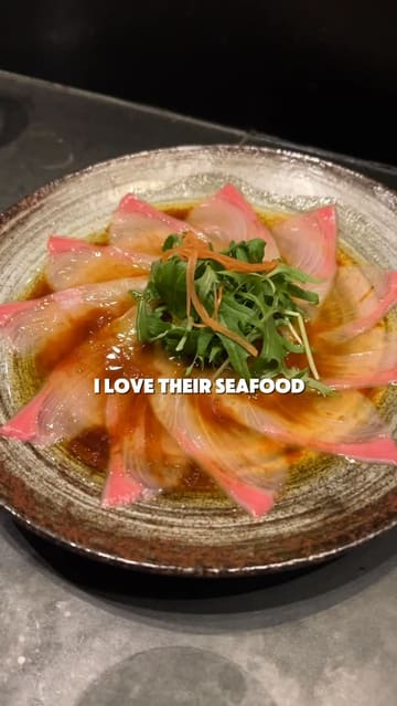 A review of the express lunch menu at Roka, showcasing various dishes like sushi, miso soup, seabream, baby chicken, and mochi ice cream, while highlighting the open kitchen and robata grill.