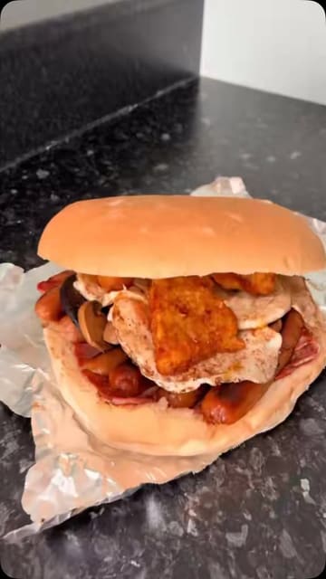 A review of the 'Monster Mega Cob' from Porchester Cafe in Nottingham, detailing the ingredients, price, and the scale of the breakfast sandwich.