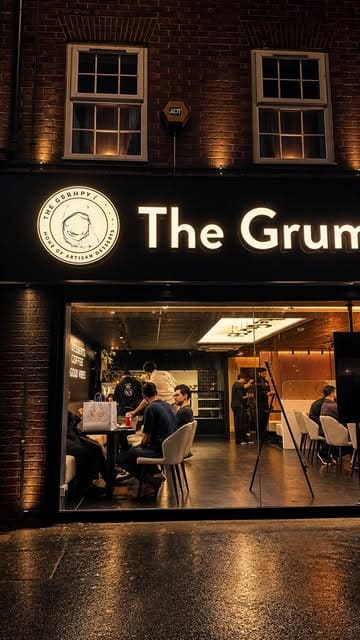 A promotional reel for The Grumpy Baker in Manchester, featuring close-up shots of various cheesecakes, indulgent desserts, and specialty drinks like matcha and iced coffee, set within their new venue.