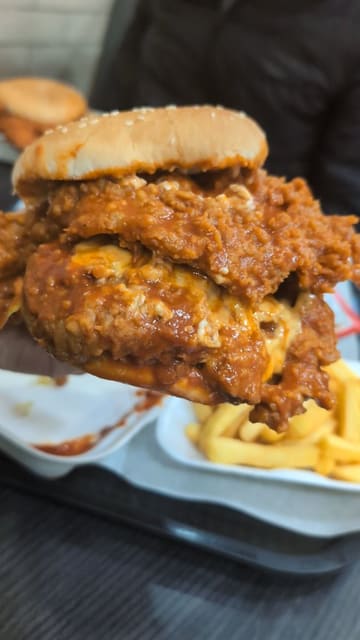 A short, text-led review of a spicy chicken burger from 3 in 1 Burger in Birmingham, focusing on the texture and sauce of the food.