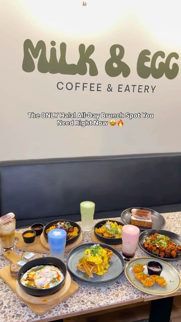 A short, fast-paced montage showcasing various brunch dishes, desserts, and drinks at a cafe called Milk & Egg. The video features close-up shots of food being prepared and served, highlighting the aesthetic presentation of the items.
