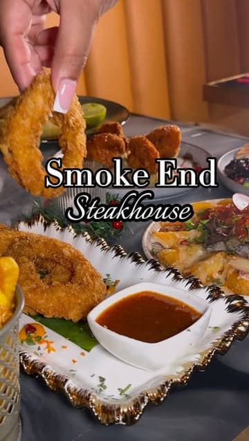 A promotional reel for Smoke End, a steakhouse in London, showcasing their interior decor and a variety of dishes including steaks, burgers, seafood, and mocktails.