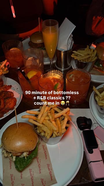 A high-energy, music-led reel showcasing a 'Slow Jams Bottomless Brunch' at The Blues Kitchen. The video features a group of friends enjoying cocktails, burgers, and fries while dancing to R&B music, effectively highlighting the venue's lively social atmosphere.