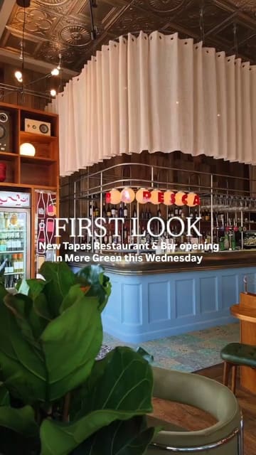 A promotional video showcasing the interior design and atmosphere of a new tapas restaurant and bar, Baresca, in Mere Green. The video features a montage of the venue's decor, bar area, and outdoor seating, set to music with text overlays announcing the opening.