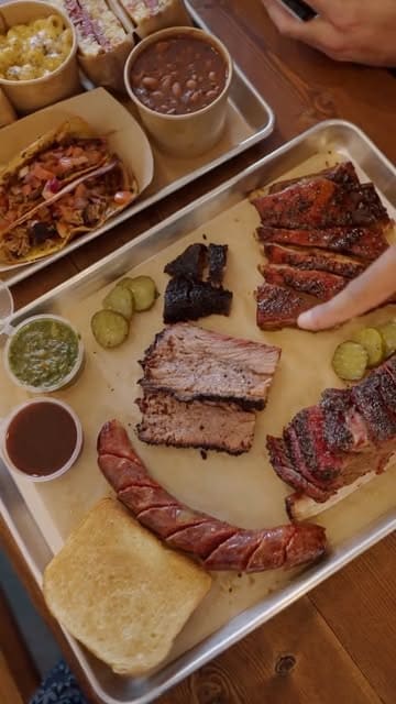 A review of Fort Smokehouse in Norbury, featuring a variety of smoked meats including brisket, pastrami, lamb ribs, and sausages, along with sides like mac and cheese and beans. The creator provides a taste test and rating for each item.