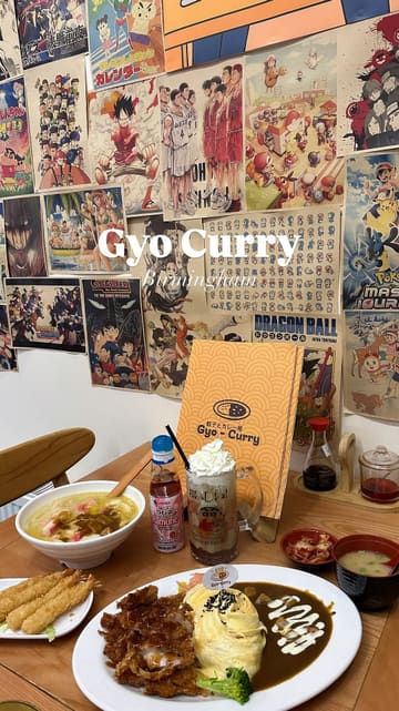 A short, music-led montage showcasing the interior, menu, and various dishes at a Japanese curry restaurant. The video features shots of the exterior, the anime-themed decor, and close-ups of the food and drinks.