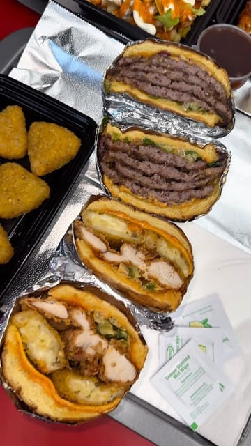 A review of The Burger Firm, showcasing their menu, interior, and specific dishes like the 4x4 smash burger, mac and cheese triangles, and halloumi fries.