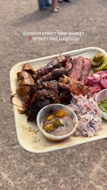 A montage video showcasing a visit to Herbert's Yard, an outdoor street food market in Longbridge, featuring various food vendors including BBQ, desserts, and chicken dishes, alongside shots of the venue's seating area.