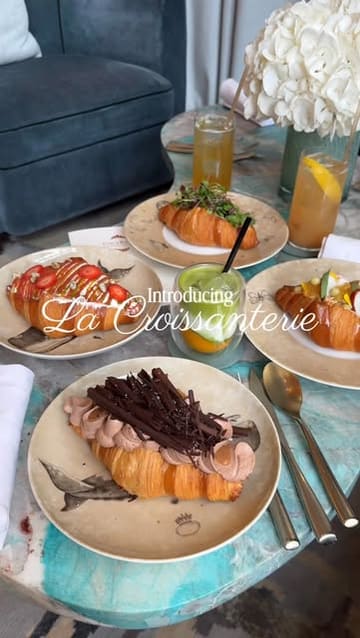 A short, aesthetic promotional video showcasing the launch of 'La Croissanterie' at Pavyllon London, featuring close-up shots of various sweet and savoury croissants and a matcha latte.