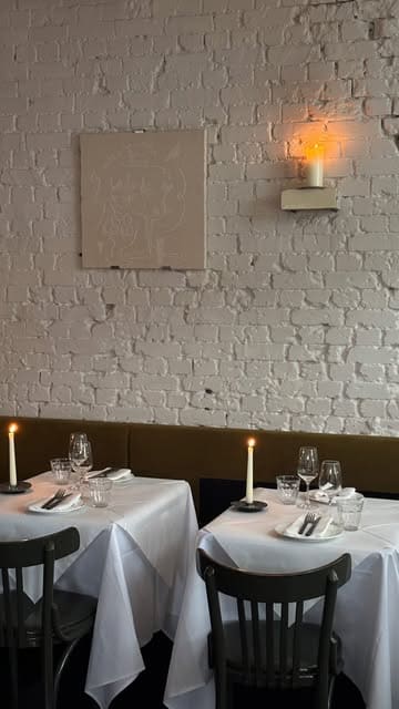 A short, atmospheric montage showcasing the interior and food at Vesper restaurant in Exmouth Market, London. The video features shots of candlelit tables, a burger, and a mortadella dish, highlighting the venue's aesthetic and walk-in availability.
