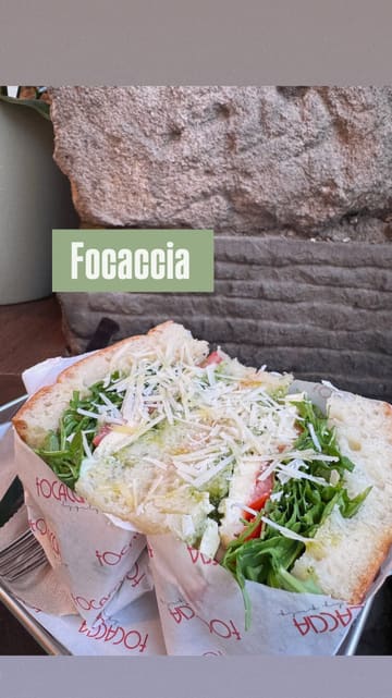 A short, handheld-style video showcasing a sandwich shop called Focaccia. The video features shots of the exterior, the menu, the staff preparing food, and close-ups of the sandwiches and coffee.