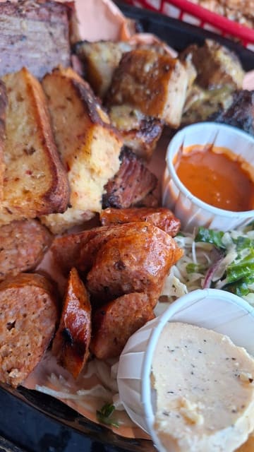 A food review video showcasing new BBQ platters, buffalo wings, spice bag fries, and a brisket burger at The Railway in Ringwood, accompanied by a beer in the garden.