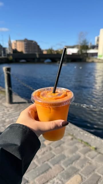 A personal vlog documenting a Saturday morning in Leith, Edinburgh, featuring a walk along the water, a visit to a coffee roastery, a local market, a lifestyle shop, and a cafe for pastries and juice.