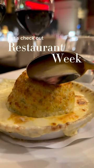 The video features a series of slow, cinematic pans over several dishes served at 21 in Newcastle, including a cheese soufflé, pheasant terrine, daube of beef, and pork belly. The footage is set to music with text overlays identifying the restaurant and the event (Restaurant Week).